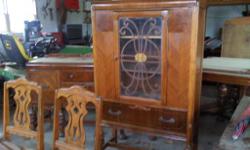 Antique Dining Room Set with Waterfall design. Beautiful Table has butterfly leaf and carved legs as you can see in the cell phone picture. 6 upholstered chairs (the one pictured has arms) Sideboard and hutch all match. Medium sized pieces. $1500 OBO Can