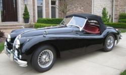 1957 Jaguar XK140 MC Roadster black with red interior. Matching number car. This is an absolutely beautiful older restoration.