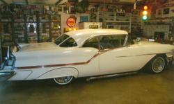1957 Oldsmobile Super Rocket 88 , 2 door H.T. This award winning car has been featured at World Of Wheels Show, and GoodGuys as well as DSR Racing. This nice example of the 50's Cruiser has the hard to locate and Luxury of the Continental Kit with a