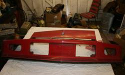 Front bumper cover from a 1987 Chevy Camaro. The bumper is used, but in good condition. It has no cracks or breaks. It is red with black stripes. (See photo)
