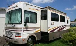 Ford Triton V-10, 3500 Watt Onan Generator, RV Completely remodeled interior with Cream Leather Throughout including the Booth Dinette, Cream Leather Recliner to match sofa, 2 Flat Screen TVs, Queen Island Bed, Mirrored Wardrobe Suite, Center Bath with