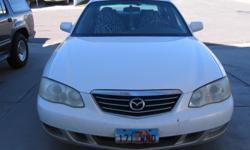 White 4-door 2002 MAZDA MILLENIA for sale.&nbsp; Automatic transmission has 194,698 miles on it.&nbsp; Power windows and locks. Has a sun roof but needs new switch. Nice leather interior, clean. We also have 4 extra rims, 2 of which have snow tires on