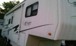 2004 Carriage Compass Cameo LXI Fifth Wheel F32 Exterior Length 32'11" 2 slides Generous rear cargo storage areas Angled Roof design and water shield Exterior Molding resists mold and mildew Spacious upper and lower custom cabinetry and banks of drawers