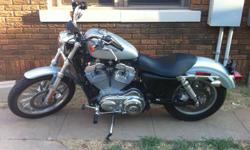 Silver 2005 Harley Sportster XL883 with 2500 miles. Excellent condition.