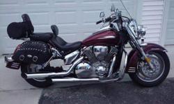 Candy Black Cherry, 16,300 miles, 1300 cc, lots of extras including windshield, driving lights, engine guard, front tool bag, Mustang seat with driver's back rest, passenger back rest with luggage rack, leather saddlebags, chrome license plate holder,