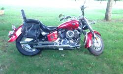 2007 Yamaha Vstar Classic. Like new, less than 500 miles. Motorcycle is red with custom chrome pipes and crash bars. Includes saddle bags. One owner. Must sell. Owner disabled. Call -- for more information.
