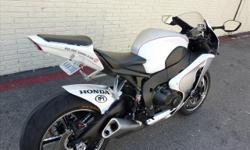 YOU ARE LOOKING AT A NEARLY NEW 2008 HONDA CBR 100RR ROLAND SANDS CUSTOM WITH ONLY 530 ACTUAL MILES ON IT. IT IS WHITE AND SILVER IN COLOR WITH RED CUSTOM GRAPHICS. IT IS POWERED BY A 998CC ENGINE AND 6 SPEED TRANSMISSION.
THERE ARE MANY EXTRAS ON THE