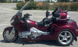 This 2009 Roadsmith Goldwing GL18HPM trike is loaded, has Independent Rear Suspension, driver backrest, premium audio, cb
radio, passenger armrests, cruise control, reverse, wing guards, highway pegs parking brake, and trailer hitch!