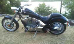 &nbsp; Under 2,800 miles, black with blue & gray pin stripping by the Wizard.&nbsp; Awesome chopper style with smooth ride and power.&nbsp; 1300CC, stretching nearly 6? from axle to axle, 21? front wheel, transmission and ABS brakes. &nbsp;Long, lean &