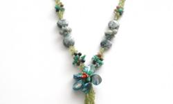 It's made of Moss Agate, Peridot and Jade.
26 inch length
5 inch long strands hanging stones and flower pendant
Vibrant soft green color necklace
Hand made
http://www.whitejasper.com