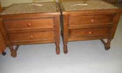 We have two very nice wooden end tables with pink, gray and white marble tops. These are very well made tables with no pressboard involved. They have doors which open on the front side for storage of various items. They are a meduim brown color and