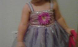 Lil girl pagent dresswith sraps light purple with flower in middle. Comes ith bow n necktie necklace. Showes are size 5. With a flower on s top. Only wore one time dress n shoes.