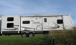 Sandpiper 301BHD,..travel trailer,..Sleeps 10,..2 slides,.. 2 separate bedrooms,..master queen sized bed in the front bedroom and a rear bunkhouse on a slide-out with a double bed on the bottom and a single bed above,..extra wide living/kitchen area with