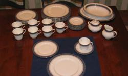 8 place settings of Sherbrooke pattern by Doulton.
8 cups and saucers
8 dinner plates
8 salad plates
1 sugar and creamer
2 11" serving bowls
1 14" oval serving platter
White china with blue and silver band around outside edge of plates.
Like new. Used