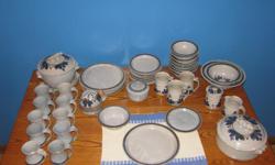 47 pieces of hand-thrown pottery dinnerware by David Nelson.
Taupe background with dark blue stripe around outside of plates. Each piece is handmade and therefore unique. In good condition.
6 dinner plates
10 salad plates
10 cereal bowls
3 mugs
10 cups
1