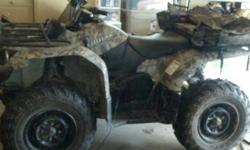 GREAT CONDITION CAMO COLORED FOUR WHEELER... USED VERY LITTLE.. AND ONLY ON 3 REAL RIDES, REST OF THE TIME USED ONCE OR TWICE A MONTH TO GO TO THE BARN ON LEVEL GROUND.. HAS NEW BATTERY AND TRICKLE CHARGER. ALSO HAS PACK BAGS ON BACK IN SAME COLOR WITH