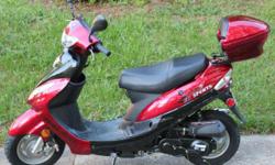 This is a brand new red Peace Sports 2011 50cc scooter. The scooter also comes with a 6 month warranty and a free half helmet.
There is plenty of storage under the seat, a locking trunk, and pockets in the front under the ignition.
Looking for ways to