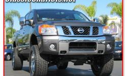 2008 Nissan Titan LE 4x4 Quad Cab. Looking for a massive 4x4 truck? Check out this Nissan Titan! This truck comes with powered running boards that retract under the cab when no doors are open, you get a slide rear window as well and massive chrome wheels!