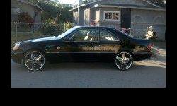 Car is black in color has 22 inch rims and a custom sysytem. Car is very clean!