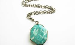 Beautifully&nbsp;designed natural stone pendant&nbsp;necklace handmade using a larga focal amazonite bead. This amazonite long gemstone pendant necklace is wire wrappped and attatched to a long brass plated chain with a handmade hook clasp.&nbsp;
This