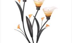 Gracious curves and warm amber glass add a strikingly sensual appeal to this three-tealight candlebra. Add the amber glow of candlelight to this elegant Art Noveau sculpture for a truly stunning display! Iron with glass and acrylic accents..(3) TEALIGHT