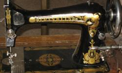 Antique Franklin Sewing Machine in ornate solid wood cabinet. 561-688-3970