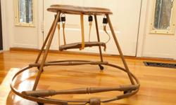 Antique 1910's Baby Walker made of bent maple and cast iron with suspended seat held by springs and leather straps.
The side supports connect to the bottom with original cast iron holders.
This would be great for a vintage display or a neat seat for an