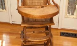 1890s Victorian oak high chair&nbsp;
Sits up straight as a high chair with adjustable levels and pulls down into a rocker.&nbsp;
The overall size of the chair is 16 inches wide, 21 inches deep, 41 inches to the top of the chair, and 32 inches high to the