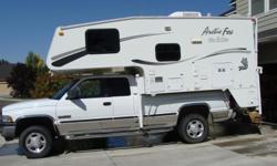 2005 Arctic Fox Camper 990 Fiberglass Camper has the following options: Extended Cab/Exterior Shower, Water Heater By-Pass Valve for winterizing, 60 X 80 Queen Bed Inner Spring Mattress, Microwave Oven/Range Cover, 2 30 gal propane tanks. 2 deep cycle