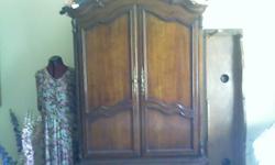 Men's Armoire with built in shelves for clothing within the two doors. Beneath are two large drawers. Cherry wood. Made Bombay style (two pieces). Manufacturer, Century. (see other ad) Belongs to set (dresser, mirror, and two bedside end tables).