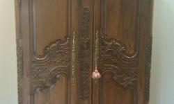 Beautifully carved French armoire circa 1850. Originally purchased for $12,000. Has the ability to carry television 40"+. Stands 8' feet. The crown is not in the pictures but comes with the armoire, has a slight crack on the right, reason for
