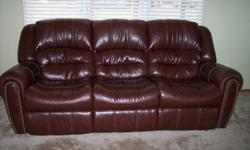 Ashley leather couch and loveseat. Couch reclines on both ends. Both ends of loveseat recline. Less than one year old. Cost 1800 new, will sell for 1300. Brown leather with brass button accents. Beautiful. Can send pics on request. Call for faster reply