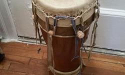 Authentic African drum (N'der) from Senegal, West Africa for sale. &nbsp;The shell is hand carved in dimba wood only found is Senegal . The goatskin heads are tensioned by a webbing-peg system. &nbsp;Tuned by adjusting length of webbing under tuning