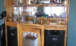 BAR SET IS GLOSSED FOR BETTER PROTECTION ALL WOOD. HAS MIRRORS ON THE OUTSIDE OF ONE SIDE ON THE FRONT HAS A DOOR WITH MIRROR ON THE FRONT OF THE BACK AND THE SIDE. HAS A CAPACITY OF 90 WINE BOTTLES NOT INCLUDED BUT A CAPACITY OF 160 WINE CUPS INCLUDED