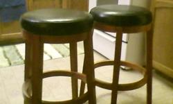 kitchen bar stools, wooden legs with black leather top.
