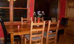 Beautiful & unique Dining table & 4 chairs. Table is made from barnwood by an artist in BlurRidge, Ga. It is long and fairly narrow, and can seat 6. Chairs are solid wood with leather-look seats. I also have a matching hutch (matches the chairs) that is