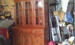 Beautiful maple hutch, 3 doors at bottom with 3 drawers, 3 glass doors at top with 2 glass shelves lighted top