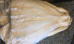 Casablanca wedding dress strapless neckline with beaded lace, silky satin and crystal taffeta pleated bodice. Never worn down the isle retail value is $1100.00 size 8 can be altered to a 4 or 12 comes with a lovely Vail and hanging storage bag.