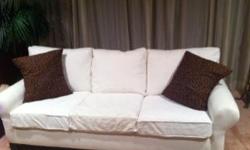 The sofa is white with two tiger print pillows. Lovely! The sofa will flatter any living room.Text me if interested at --.