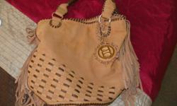 I have a BeBe purse, very soft - like new - has BeBe on rings to strap and on heart inside on zipper pocket and on on front/chain