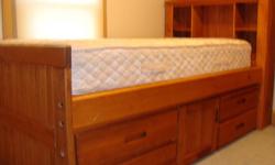 MUST GO Comfortable SINGLE bed with lots of storage in excellent condition. Head board has shelves and base has four large drawings and cabinet for additional storage. Bed consist of a solid bed board that supports a 13" mattress that has always been