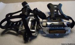 Bike flat cage pedals w/ toe clips and straps.&nbsp; New.&nbsp; From taiwan.