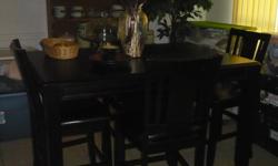 BEAUTIFUL BLK WOODEN DINING SET, TABLE IS AT A HIGHER LEVEL, CHAIRS ARE HIGH BACK WITH BLACK CUSHIONS IN ALL 4 CHAIRS