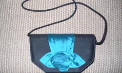 Handsome, elegant ladies' evening bag, with blue attached bow decoration. 9" by 5" high.