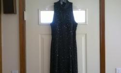 Black iridescent beaded and sequined formal evening prom gown by Roberta. &nbsp;Beads and sequins in a swirl design, keyhole front, side slit, size Medium. &nbsp;100% silk, polyester/rayon lining, invisible zipper. &nbsp;Gorgeous, figure flattering, makes
