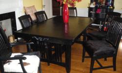 Table is 6ft-2inches long ---- 42 1/2inches wide ---- 31inches tall. The chairs are covered in fine black and white cowhide. The 2 end chairs have arms as the other 4 do not. This is in GREAT condition....Moving and must sell. See Pictures.