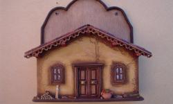 This handcrafted retablo recreates a southwestern facade with miniature pottery, tiny broom and firewood and is perfect for a mail organizer. The retablo is completely handcrafted in La Paz, Bolivia. This retablo measures 23.00 x 22.00cm and is offered