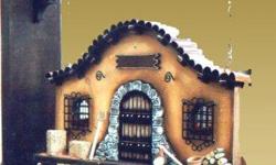 This handcrafted retablo recreates a southwestern facade with miniature pottery, tiny axe and firewood and is decorated identically on both sides. The retablo is completely handcrafted in La Paz, Bolivia. This retablo measures 28.00 x 17.00cm and is