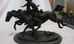 FOR ONLINE AUCTION ON JUNE 23 at repocast.com: Bronze "The Wounded Bunkie" Statue by Frederic Remington. Mounted on a Marble Base. 32"L x 15"W x 21"H. "The Wounded Bunkie" was the second of Frederic Remington's sculptures and was welcomed with critical