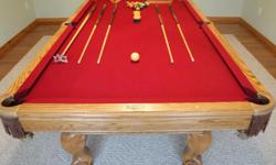 This is a standard Brunswick 8 ball table. Has a solid slate top, with burgendy cloth, leather pockets. Has 4 cue stick, cripple, table brus, cover, cue ball and all numbered balls, also oak cue rack that hangs on wall, has a removable ping-pong top with